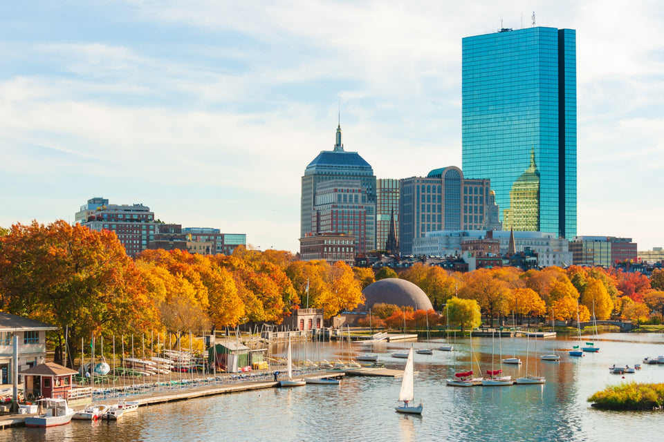 The Boston skyline across the Charles River basin, sailboats in the foreground
