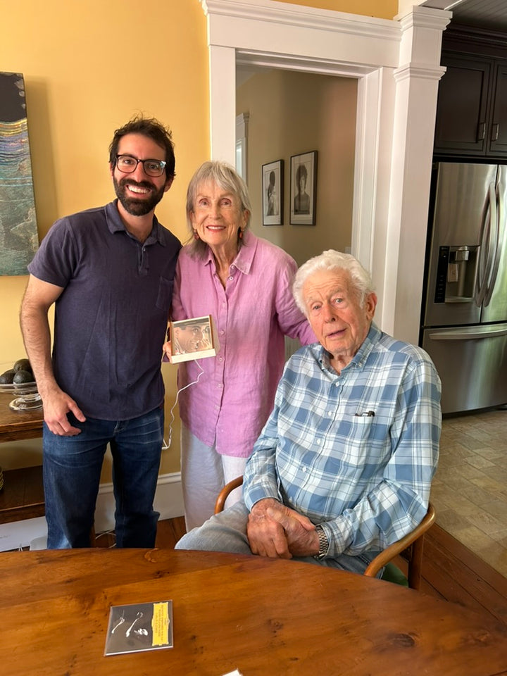Mike standing with two early beta testers in a kitchen, one holding a Spindle